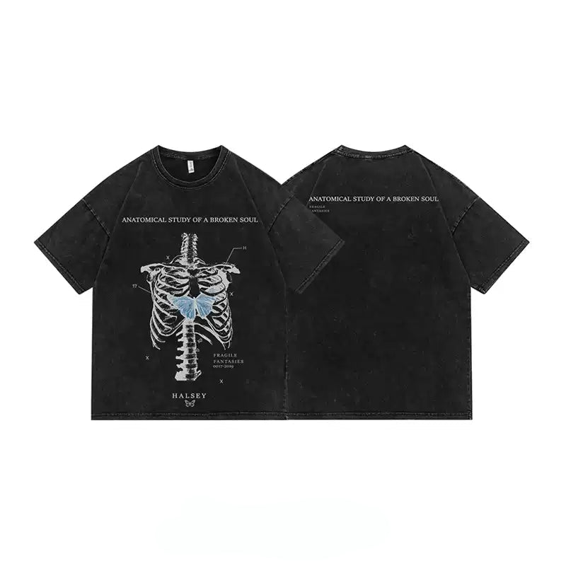Two views of a black acid-wash t-shirt with a detailed anatomical rib cage graphic on the front, featuring a blue highlighted heart and white text reading 'ANATOMICAL STUDY OF A BROKEN SOUL' and 'HALSRY'.